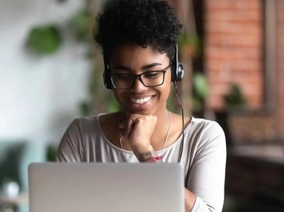 Smiling professional woman using laptop